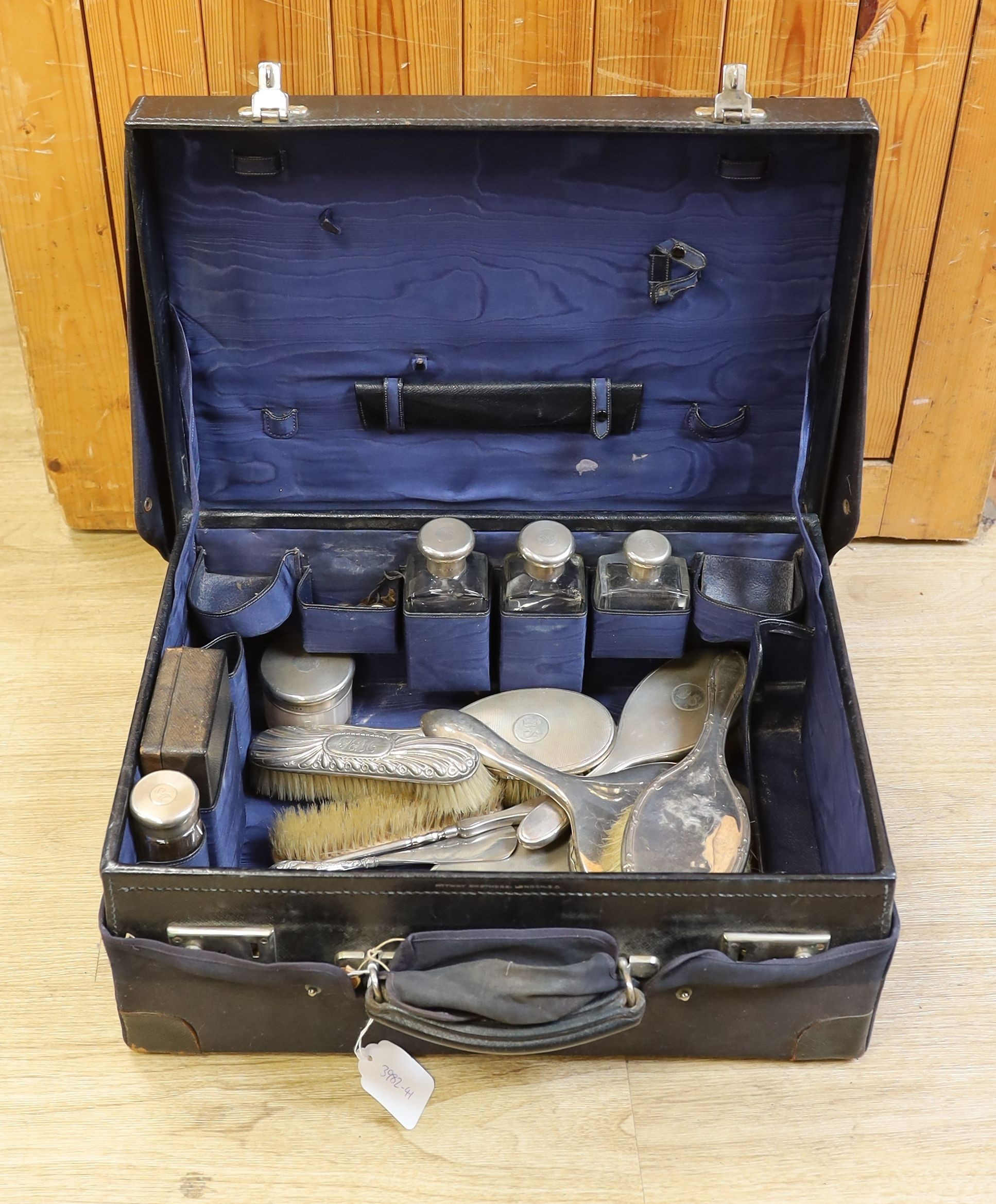 A 1930's part silver mounted glass toilet set , comprising eleven items, London, 1933 in a leather travelling case, together with five other associated accoutrements.
